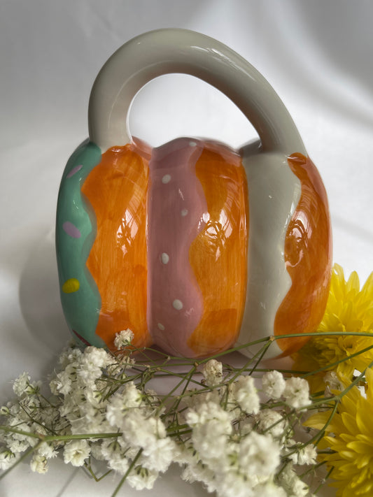 Ceramic teapot with floral design on a white background