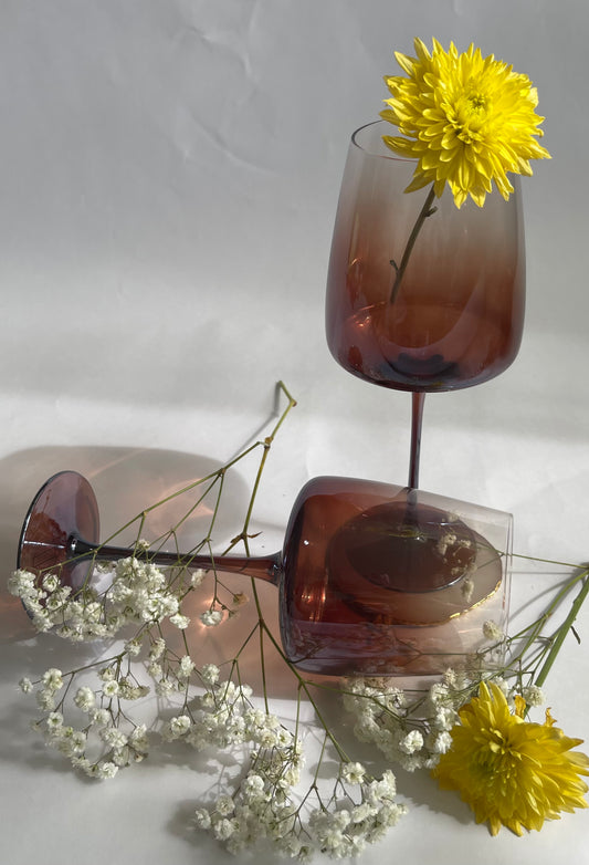 Brown wine glasses with yellow flowers on a white background